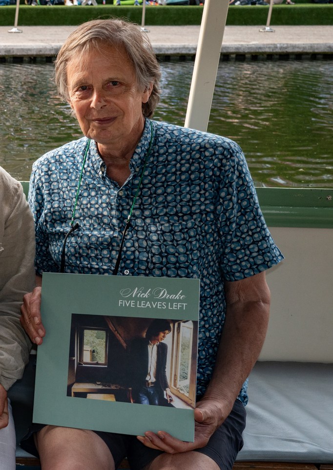 Four men holding copies of Nick Drake's *Five Leaves Left*.