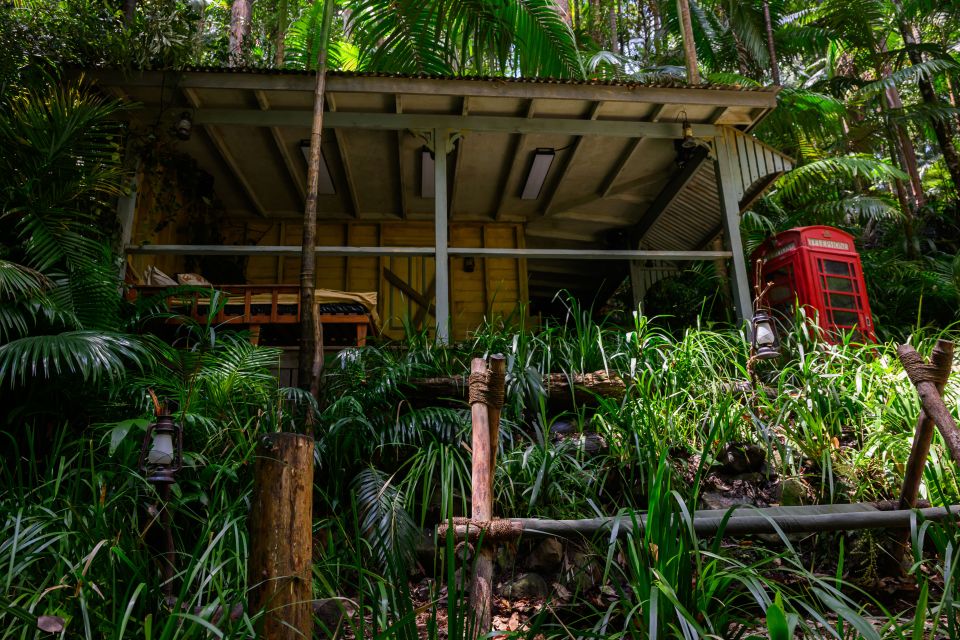 Jungle camp with red telephone booth.