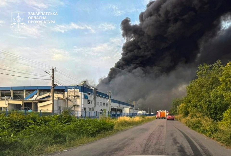 Smoke billows over a damaged industrial facility in Mukachevo, Ukraine, after a Russian missile strike.