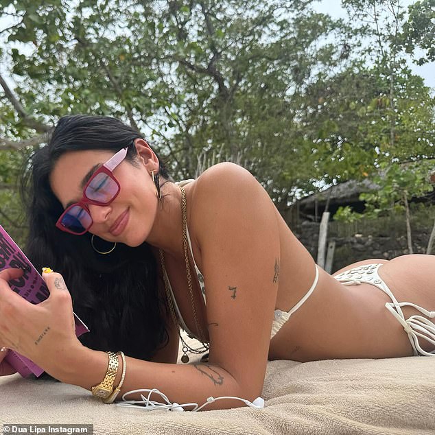 Dua was also seen soaking up the sun as she laid in the sun while wearing a pair of bright red spectacles