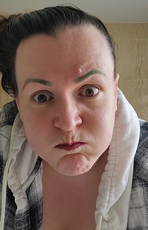 Close-up of a person with green eyebrows.