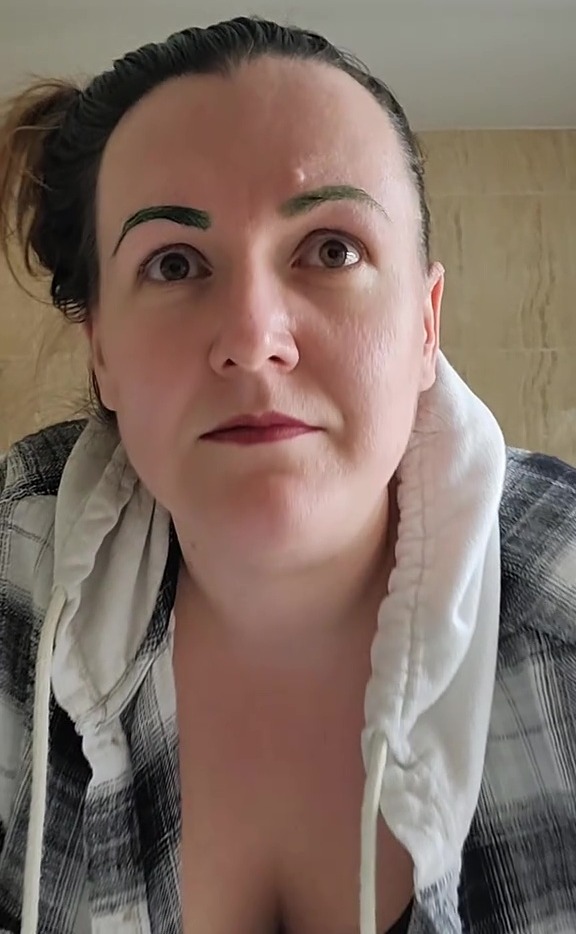 Woman with green eyebrows.