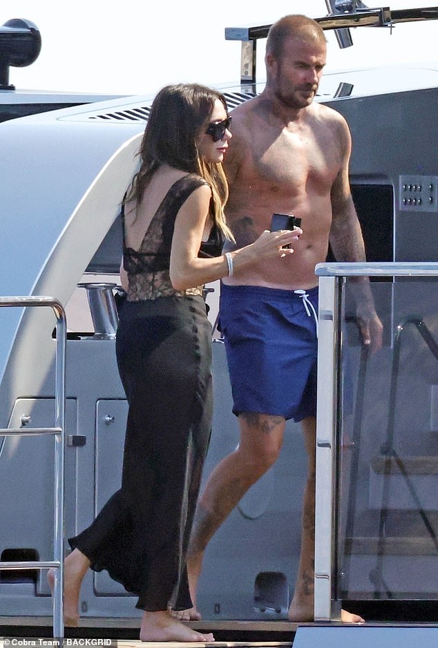 David showcased his tattooed and muscular physique as he went shirtless and topped up his tan in a pair of a navy blue swimming trunks