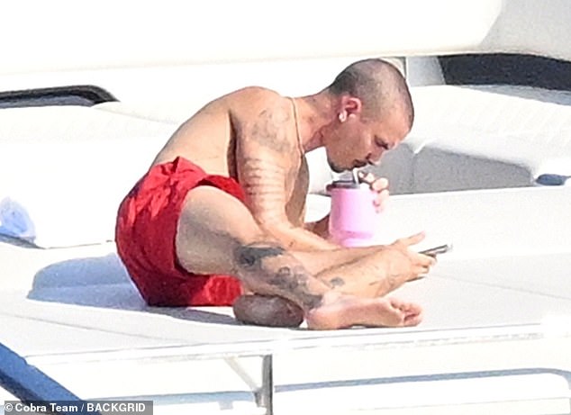 Romeo later enjoyed some alone time a cool drink while scrolling through his phone