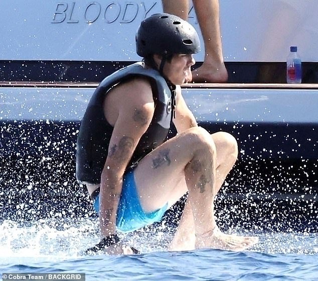 Romeo and Cruz (pictured) both enjoyed a spot of water sports as they jumped on jet skis and took turns on an electric surf board