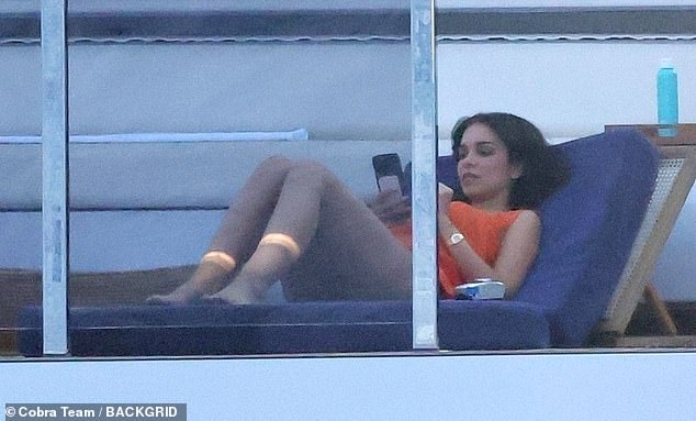Jackie looked stunning in an orange swimsuit