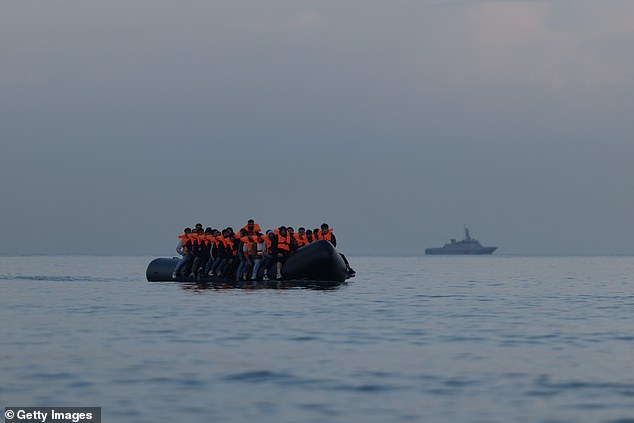 A group of people believed to be migrants are pictured on a small boat near Gravelines, northern France