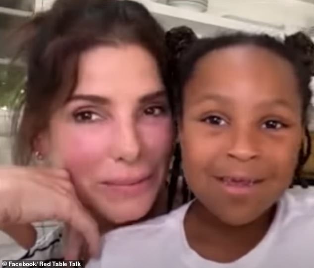 Sandra once said she 'sometimes' wishes she 'matched' her adopted African-American children's skin (Pictured with daughter Laila, then-eight, in 2021 on Red Table Talk)