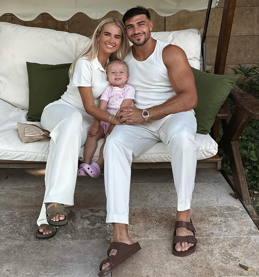 Tommy Fury, Molly Mae, and their baby sitting together.