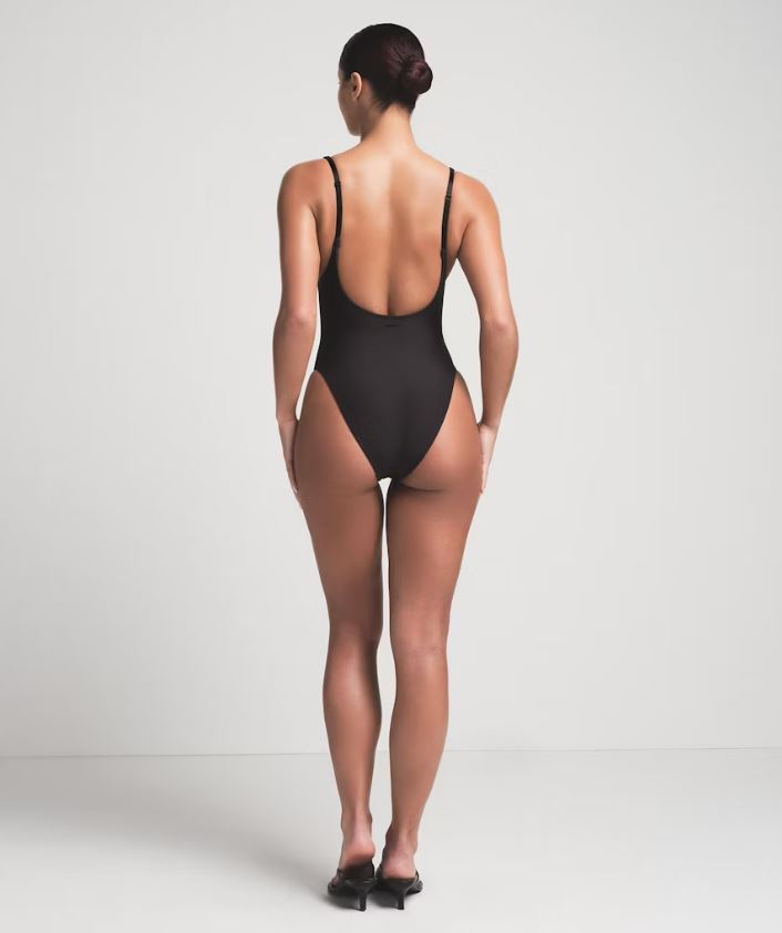 Black open-back swimsuit.