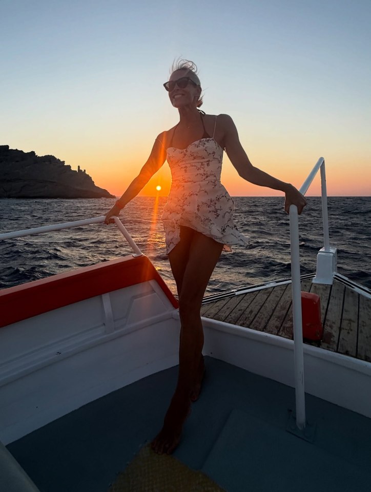 Jenni Falconer on a boat at sunset.
