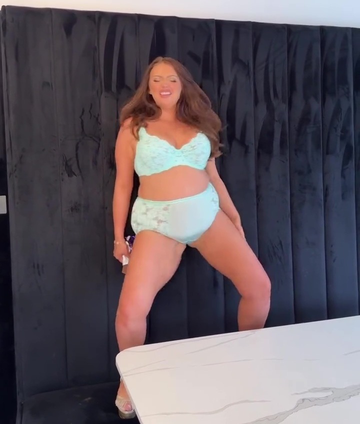 Woman in lingerie surprised by her son in the kitchen.