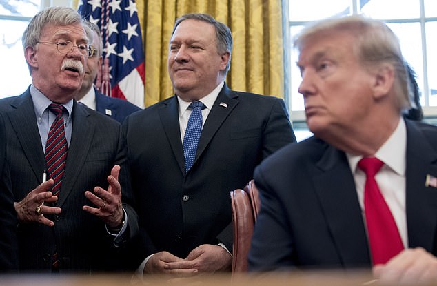 FILE - From left, National Security Adviser John Bolton, accompanied by Secretary of State Mike Pompeo, and President Donald Trump, speaks before Trump signs a National Security Presidential Memorandum to launch the "Women's Global Development and Prosperity" Initiative in the Oval Office of the White House, Feb. 7, 2019 in Washington. (AP Photo/Andrew Harnik File)