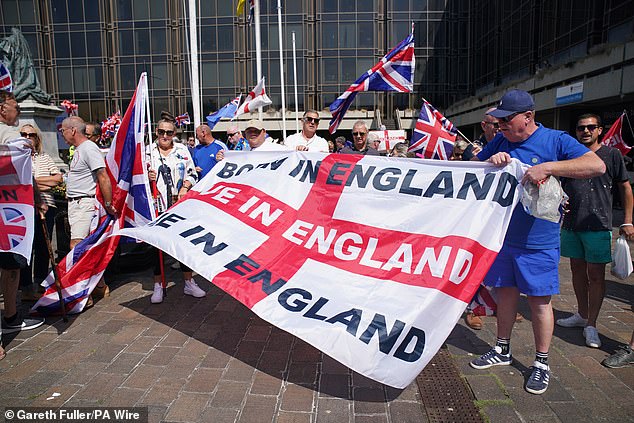 One protester had a large flag of St George which had on it the words 'Born in England, Live in England, Die in England'