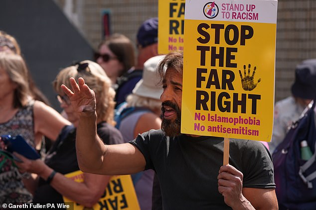 A man carrying a 'stop the far right' banner at today's Portsmouth protest