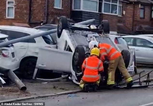 A driver and passenger had to be rescued from the upside-down Kia hatchback after it crashed and became engulfed by flames