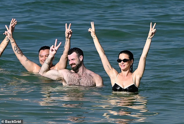 She could be glimpsed throwing her hands festively up into the air at one point, while floating around in the shallows surrounded by her pals
