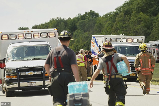 Rescue personnel work the scene of a tour bus that crashed and rolled over on the New York State Thruway near Pembroke on Friday afternoon