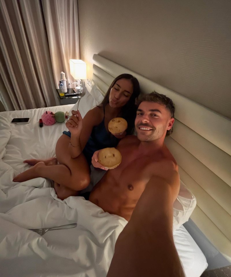 Harry and Shakira from Love Island enjoying pies in bed.