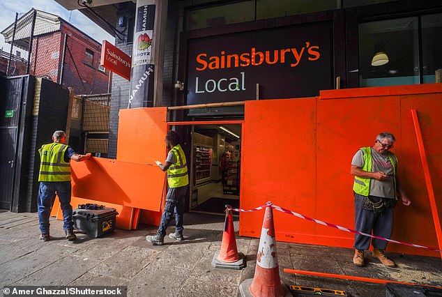 A Sainsbury's local supermarket on Ladbroke Grove is boarded up as a security measure