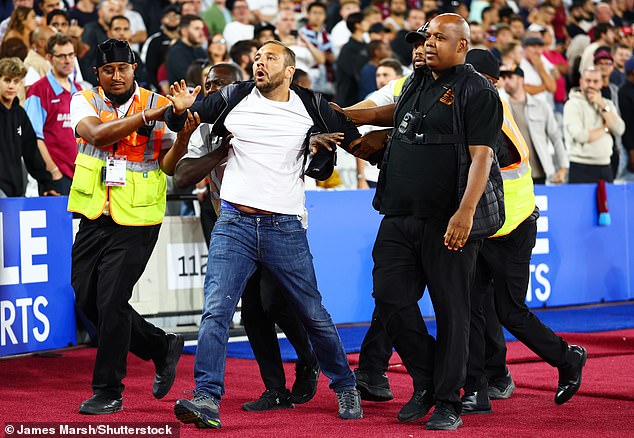 Security staff and stewards were seen escorting a fan out of the stadium in the second half