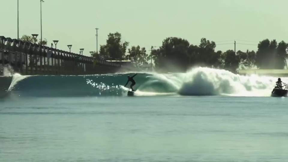 Surfer on a wave at a surf park.