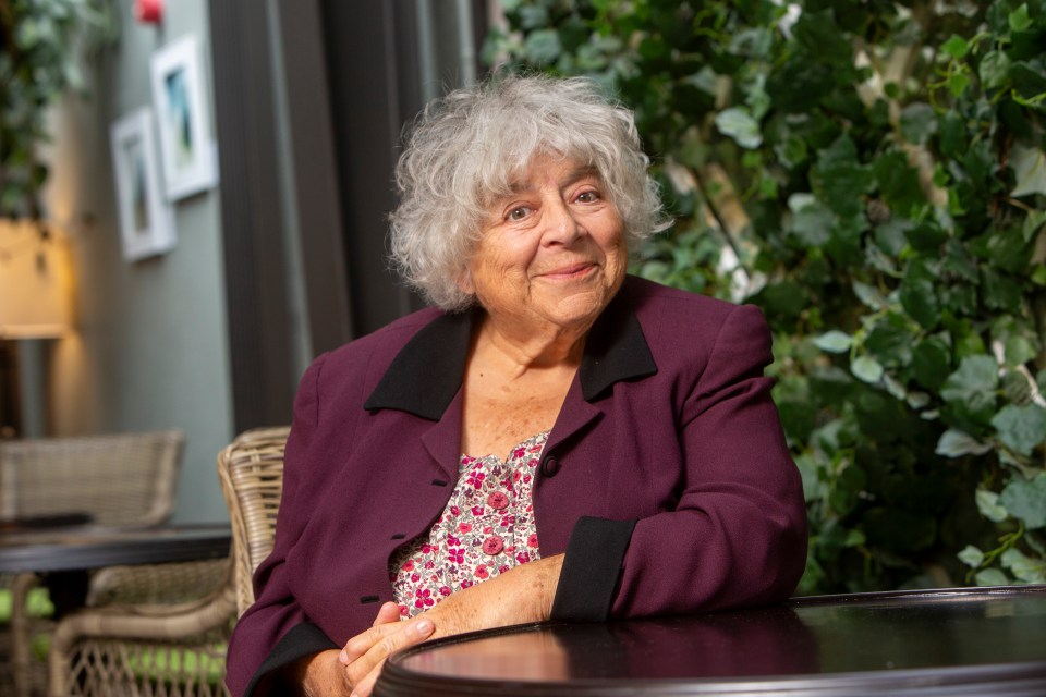 Miriam Margolyes sitting at a table.