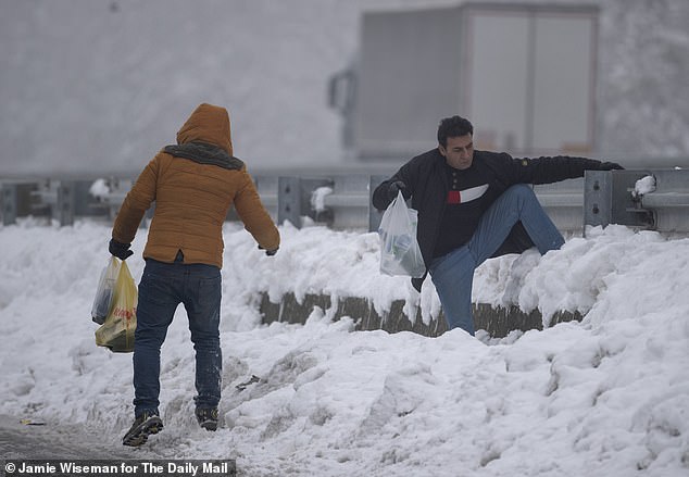 Migrants near the Adasevci migrant camp, a motorway hotel turned hostel for some of the thousands stuck in Serbia in 2018