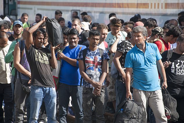 Hundreds of migrants, brought by train from the Serbian border, arrive in Zagreb for processing at the Porin Hotel Centre in 2018