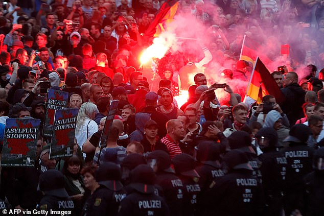 Right wing demonstrators light flares on August 27, 2018 in Chemnitz, eastern Germany, following the death of a 35-year-old German national who died in hospital after a 'dispute between several people of different nationalities'