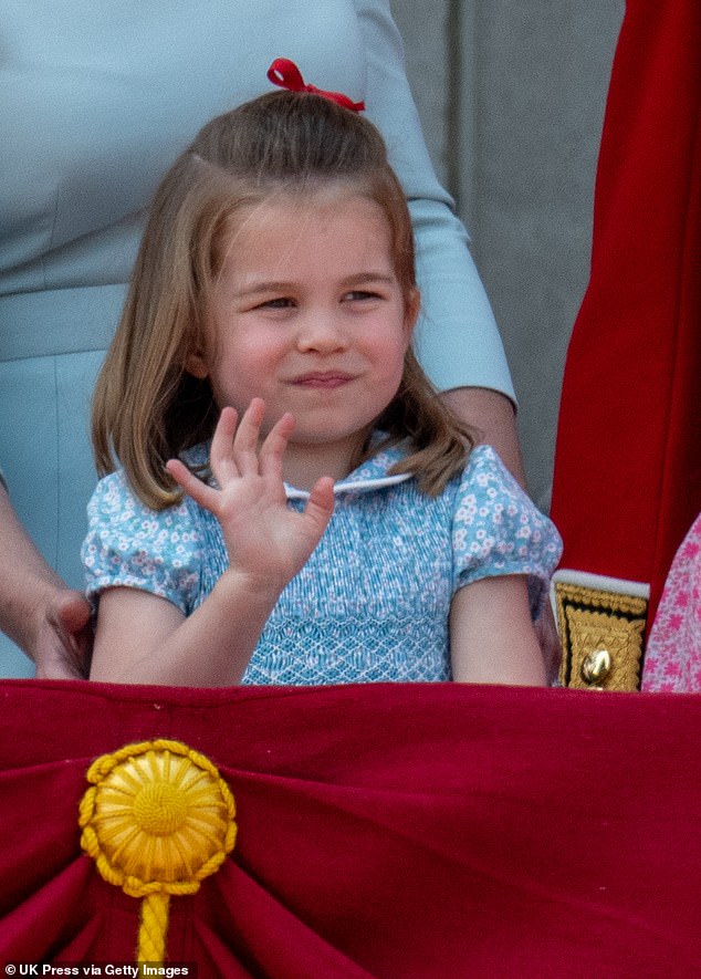 Charlotte, a true princess, smiles and waves to the crowd from the Palace balcony