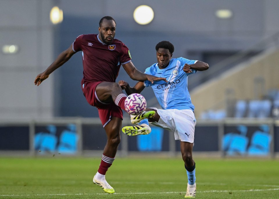 Michail Antonio of West Ham United and Femi Fapetu of Manchester City competing for the ball.