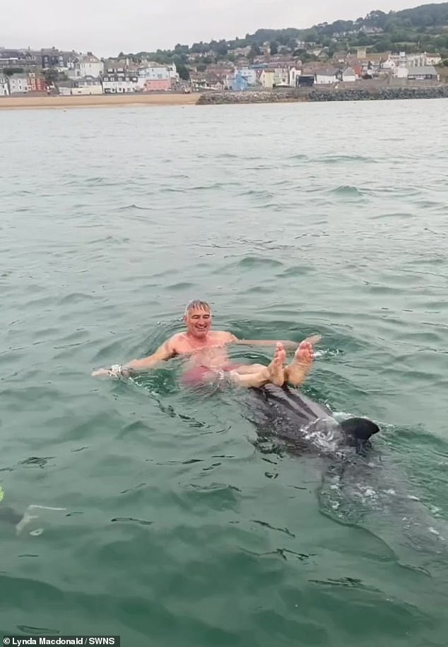 Twice now, women have had to be rescued from Reggie (seen earlier this month playing with the MacDonald family) by kayaking brothers Rhys and Gareth Paterson