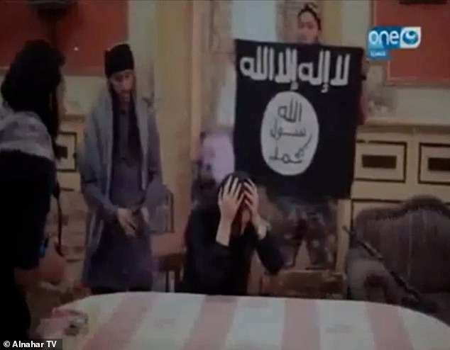 Footage taken in Egypt shows the frightened woman, named as Heba Magdi, surrounded by men dressed as militants from the terror group carrying a range of weapons