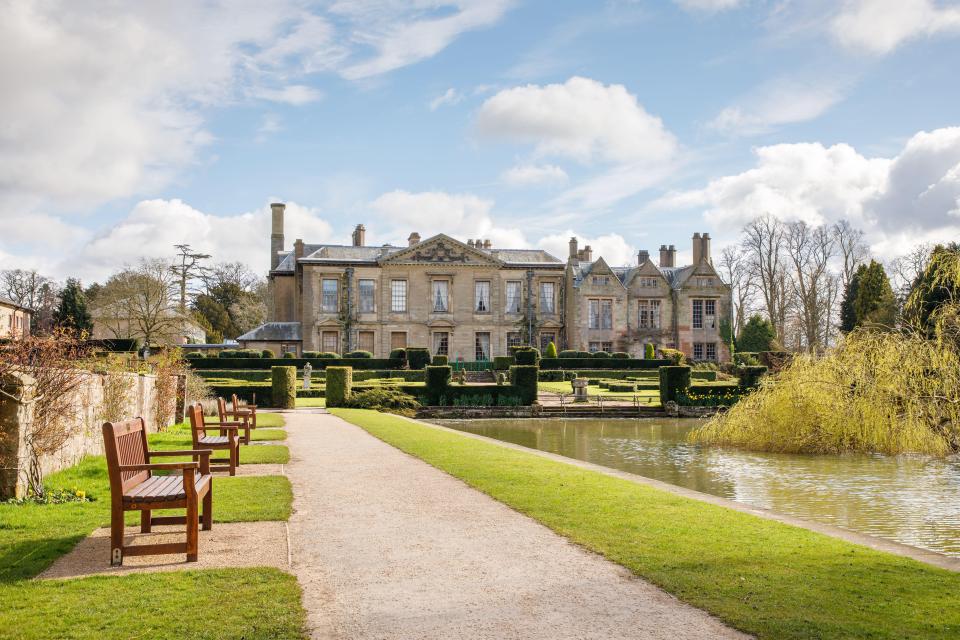 Coombe Abbey Hotel, a Grade I listed building, with its gardens and lake.