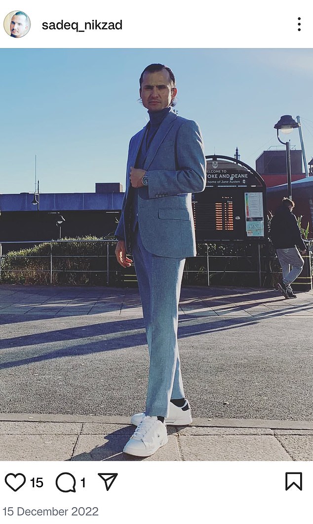 The migrant shows off a three-piece linen suit after taking a small boat from France to the UK