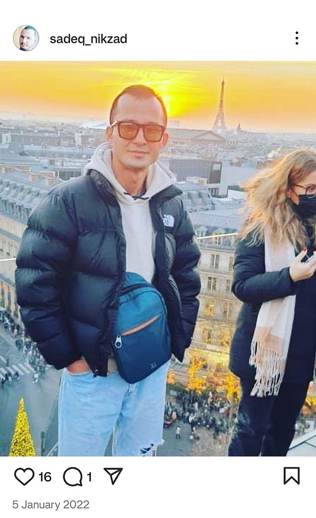 Globetrotter Nikzad is snapped overlooking the Eiffel Tower in Paris as the sun sets