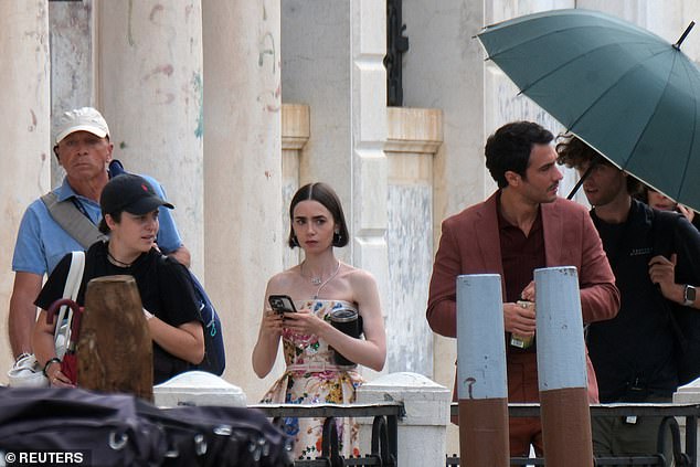 Collins, 36, was seen leaving a building and boarding a boat with her Italian co-star, Eugenio Franceschini, surrounded by crew members