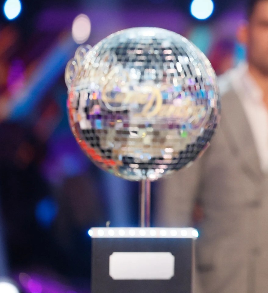 Chris McCausland and Dianne Buswell, winners of Strictly Come Dancing, holding the glitterball trophy.