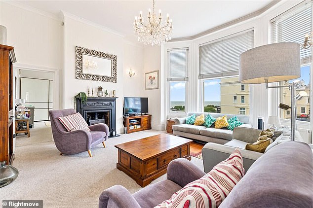 The apartment’s large living room boasts sweeping views of Hove’s seafront