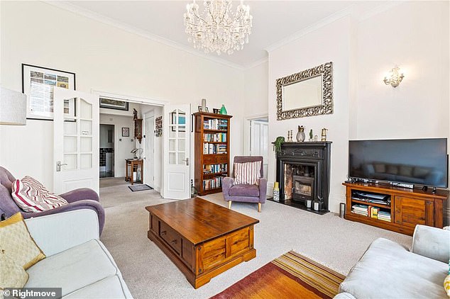 The apartment's large living room boasts sweeping views of Hove's seafront