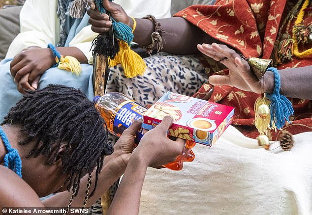 Taylor is pictured giving an offering a food to the king. Taylor, whose tribal name is Asnat, Lady Safi, of Atehene, is essentially a servant to the couple, which worries her family