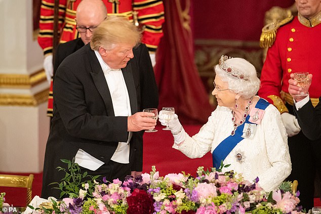 Trump and the Queen clinking glasses after delivering remarks. The president ordinarily drinks white grape juice at such functions whereas the Queen drank water