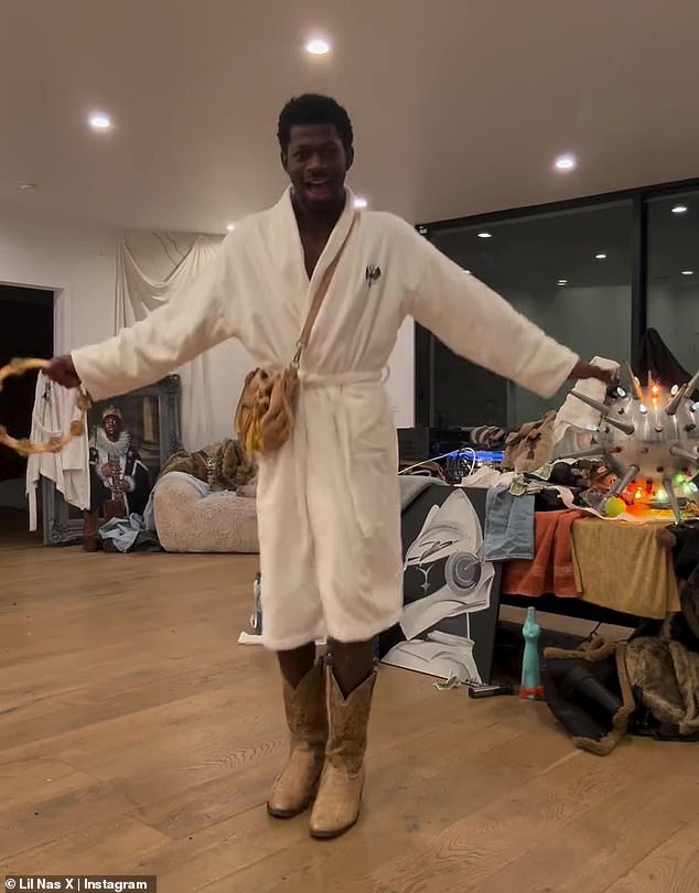 On Wednesday, the musician posted a slew of content to his Instagram account. In one video, a bathrobe-clad Lil Nas X sang and played a tambourine. 'FREE THE PEOPLE! NOW!' he captioned the post