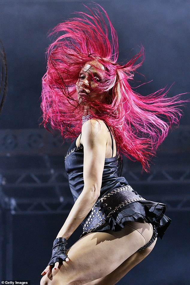 While her hair was scraped back during parts of the performance, elsewhere she wore a long, pink wig that she whipped back and forth