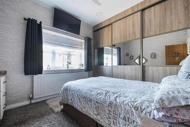 Another TV in one of the property's bedrooms is fitted immediately above the curtain pole and just fits in the gap between the ceiling and window