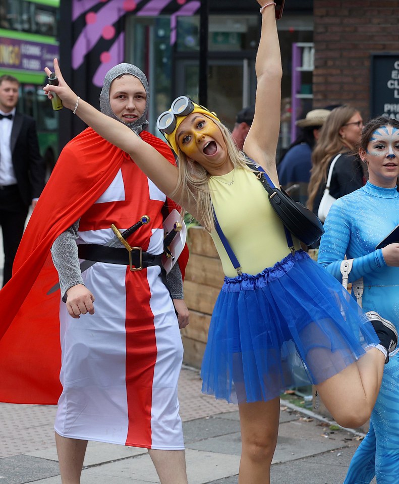 Three women in costume at a pub crawl.
