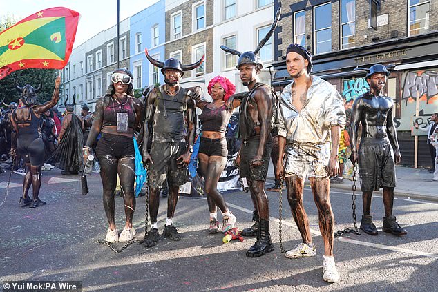 People taking part in J'ouvert ahead of the Children's Day Parade