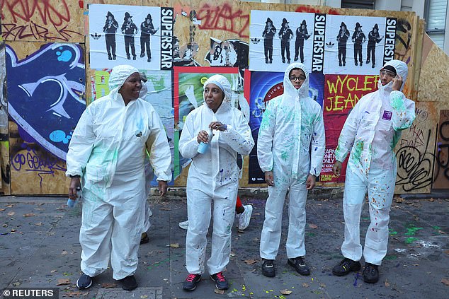 Revellers take part in the 'J'Ouvert' celebrations at sunrise during Notting Hill Carnival. Some were in white or blue overalls
