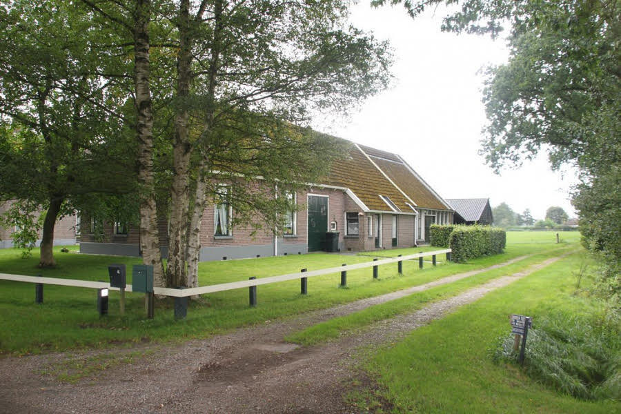 Farmhouse and grassy lane.
